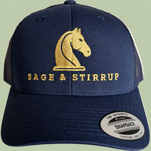 Navy trucker cap on sage background